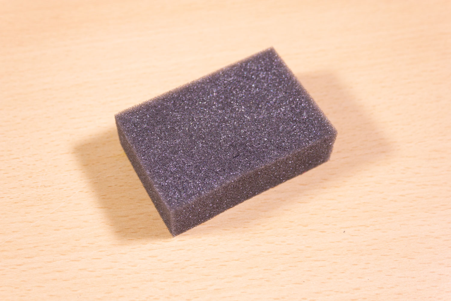 Image shows a foam eraser on a desk.