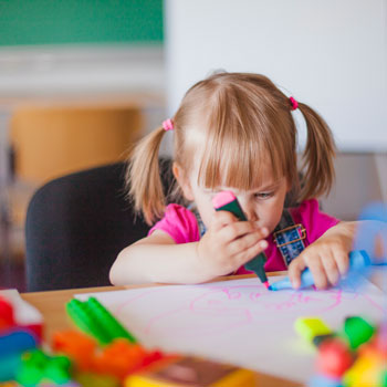 young girl using a marker