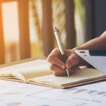 person writing in a notebook